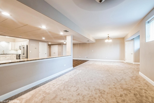 21409 Foxtail Dr, Mokena, IL 60448 - unfurnished living room featuring light carpet and recessed lighting