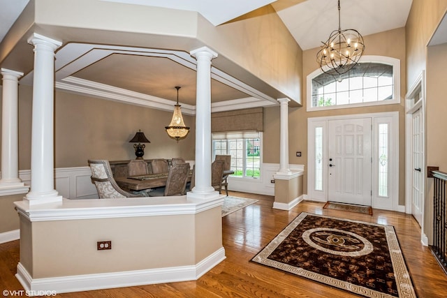 21409 Foxtail Dr, Mokena, IL 60448 - entrance foyer featuring wood finished floors, a wainscoted wall, a chandelier, a decorative wall, and ornate columns