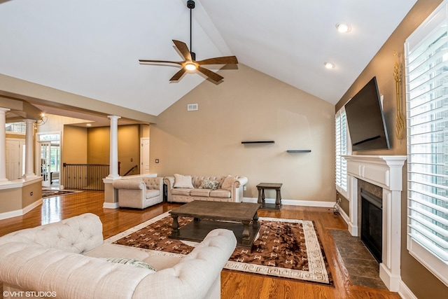 21409 Foxtail Dr, Mokena, IL 60448 - living area featuring ornate columns, a ceiling fan, a tile fireplace, wood finished floors, and high vaulted ceiling