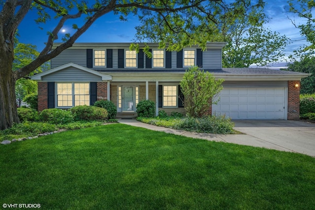 1329 Sanford Ln, Glenview, IL 60025 - view of front of property with driveway, brick siding, a garage, a front yard, and covered porch