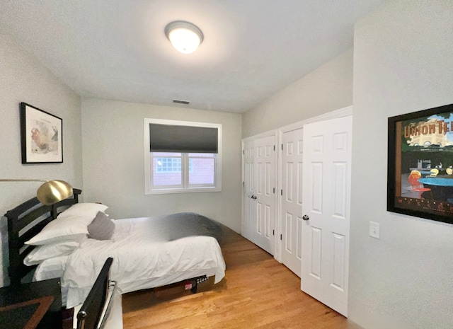 669 N Peoria St Unit 1N, Chicago, IL 60642 - bedroom with light wood-style floors and multiple closets