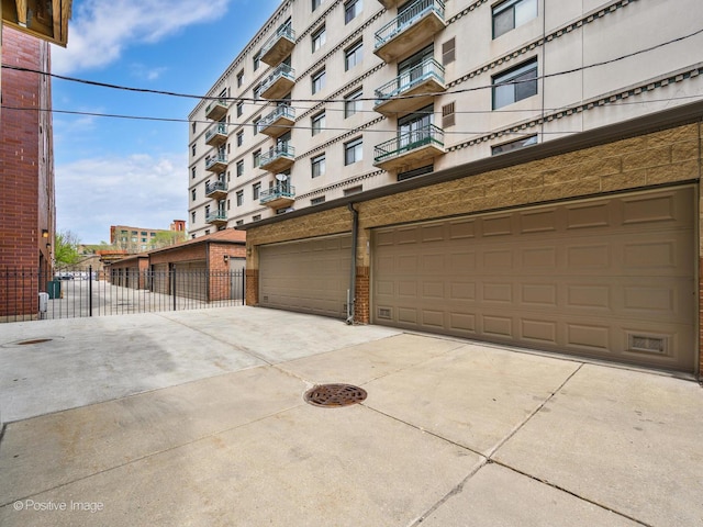 669 N Peoria St Unit 1N, Chicago, IL 60642 - view of apartment building / complex featuring concrete driveway and an attached garage