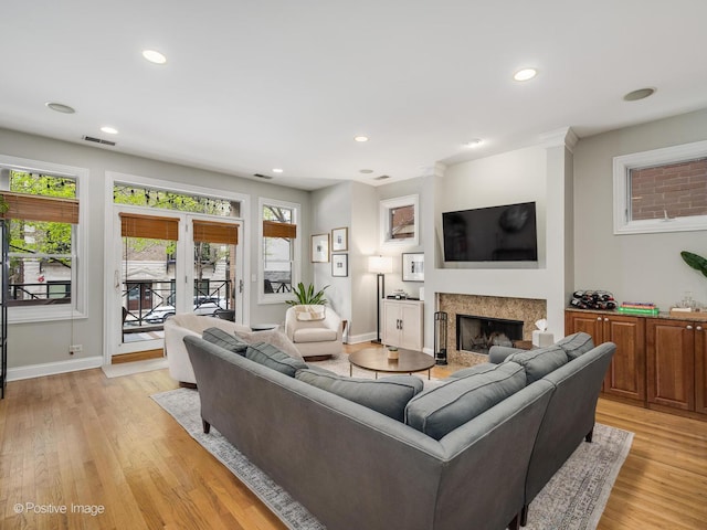 669 N Peoria St Unit 1N, Chicago, IL 60642 - living room featuring healthy amount of natural light, a high end fireplace, light wood finished floors, and recessed lighting