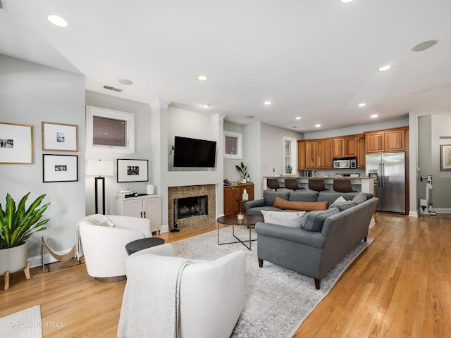 669 N Peoria St Unit 1N, Chicago, IL 60642 - living area with light wood-type flooring, recessed lighting, and a fireplace with flush hearth
