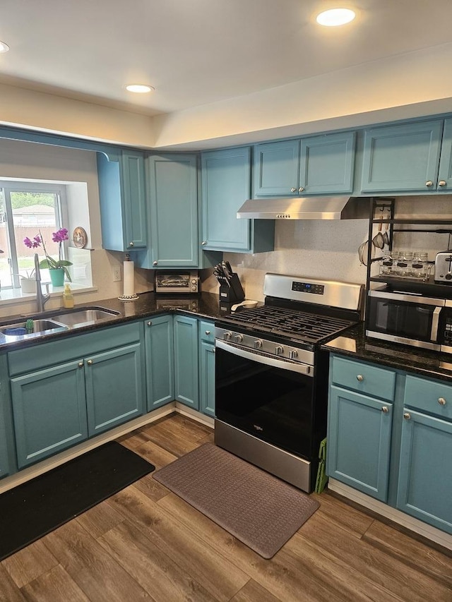 3401 S 56th Ct, Cicero, IL 60804 - kitchen featuring appliances with stainless steel finishes, under cabinet range hood, dark wood-type flooring, dark countertops, and recessed lighting