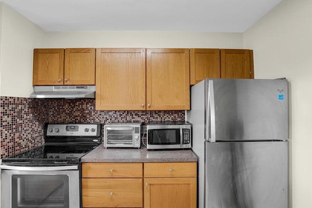 4970 N Marine Dr Unit 822, Chicago, IL 60640 - kitchen with appliances with stainless steel finishes, under cabinet range hood, decorative backsplash, and dark countertops