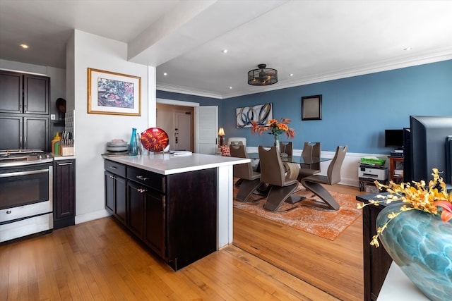 5555 S Everett Ave Unit C14, Chicago, IL 60637 - kitchen featuring stainless steel stove, a peninsula, light countertops, light wood-style floors, and recessed lighting