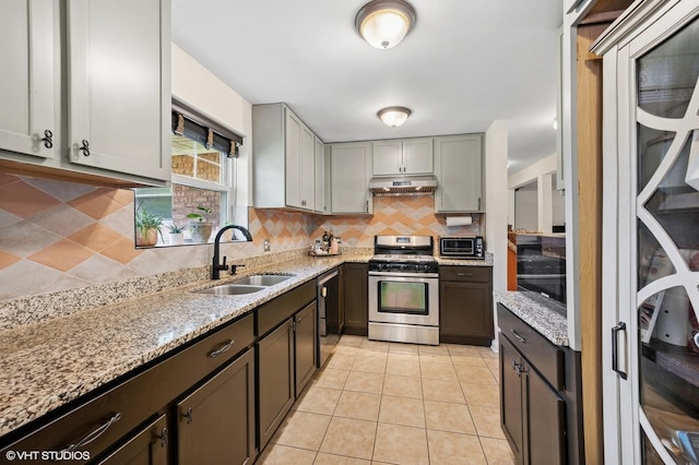 2417 Lyons St, Evanston, IL 60201 - kitchen with stainless steel gas range oven, tasteful backsplash, light stone counters, under cabinet range hood, and dishwashing machine