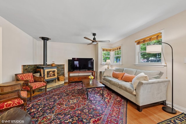 2417 Lyons St, Evanston, IL 60201 - living room featuring wood finished floors, ceiling fan, and a wood stove