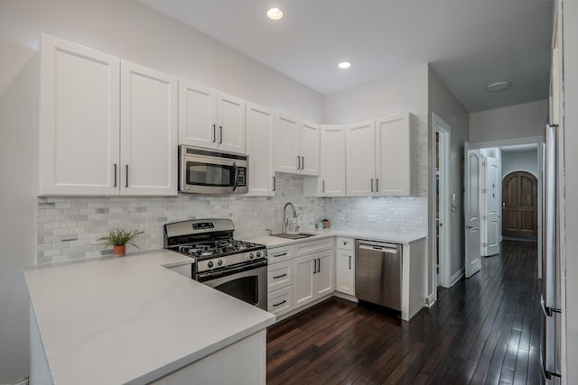 1349 W Huron St Unit 1, Chicago, IL 60642 - kitchen with stainless steel appliances, a peninsula, white cabinets, light countertops, and recessed lighting