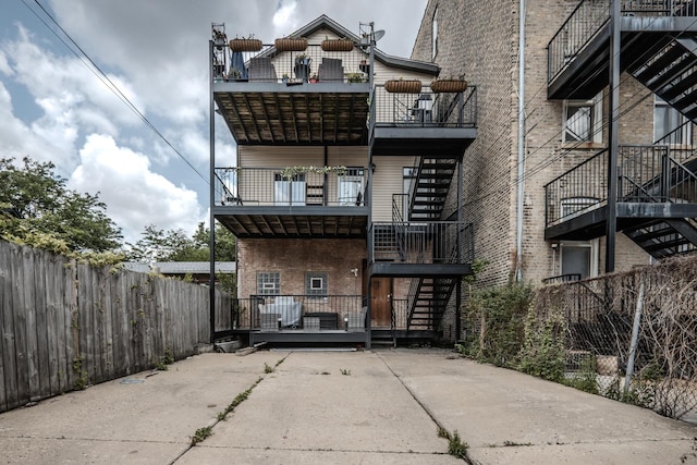 1349 W Huron St Unit 1, Chicago, IL 60642 - back of house featuring a balcony and stairs