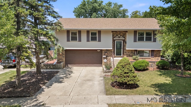 819 Stowell Ave, Streamwood, IL 60107 - raised ranch with an attached garage, concrete driveway, brick siding, and a front lawn