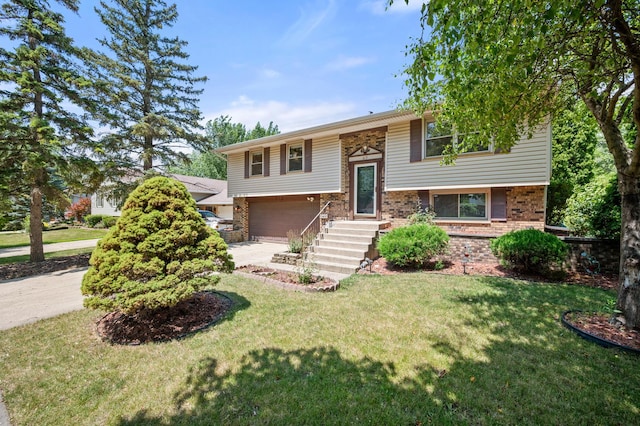 819 Stowell Ave, Streamwood, IL 60107 - split foyer home with an attached garage, concrete driveway, brick siding, and a front yard