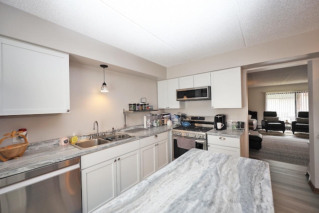 4946 Douglas Rd Unit 202, Downers Grove, IL 60515 - kitchen with appliances with stainless steel finishes, white cabinetry, wood finished floors, hanging light fixtures, and a textured ceiling