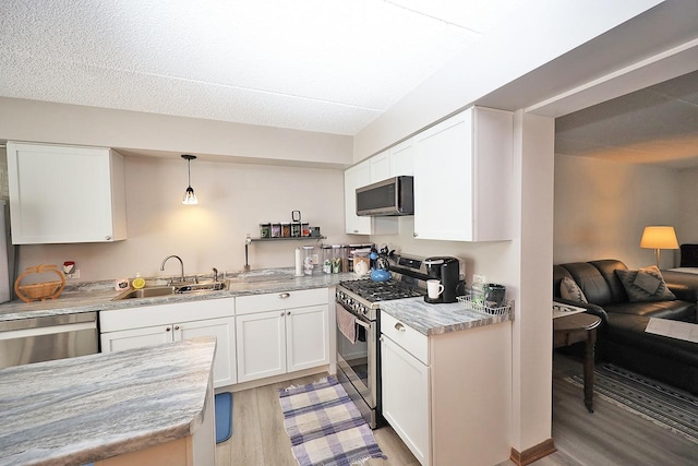 4946 Douglas Rd Unit 202, Downers Grove, IL 60515 - kitchen featuring appliances with stainless steel finishes, light wood finished floors, and white cabinetry