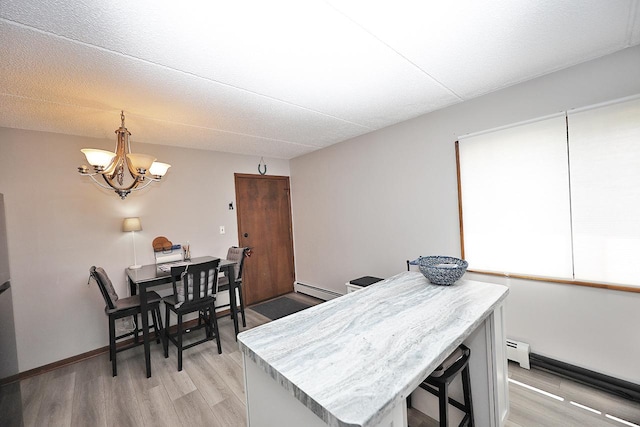 4946 Douglas Rd Unit 202, Downers Grove, IL 60515 - office area featuring a baseboard heating unit, a chandelier, and light wood-style floors
