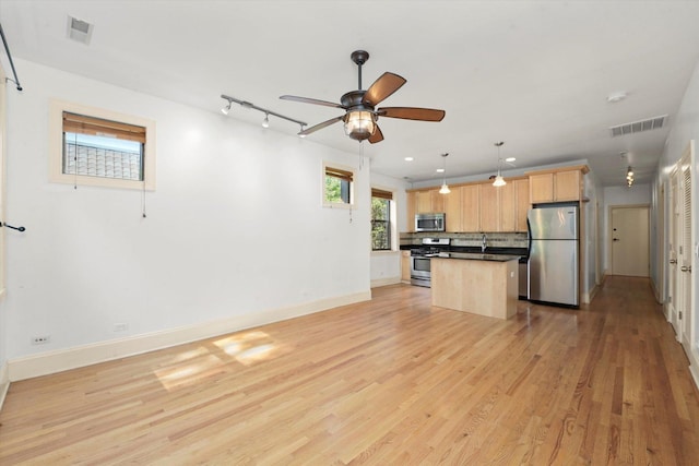 7633 N Greenview Ave Unit 3W, Chicago, IL 60626 - kitchen with stainless steel appliances, light brown cabinets, backsplash, light wood-type flooring, and ceiling fan