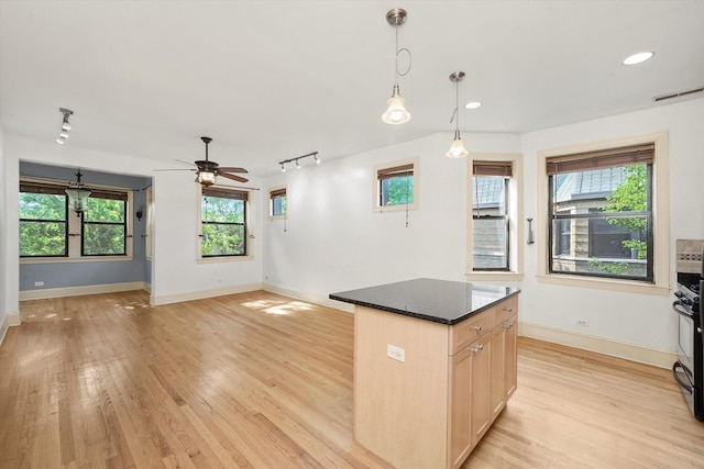 7633 N Greenview Ave Unit 3W, Chicago, IL 60626 - kitchen with light wood-type flooring, a center island, a ceiling fan, pendant lighting, and open floor plan