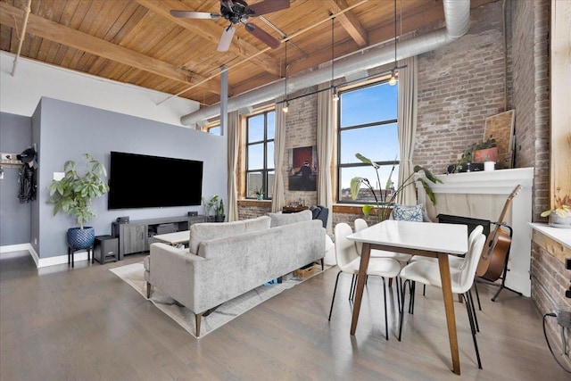 1801 S Michigan Ave Unit 701, Chicago, IL 60616 - living room with a wood ceiling with exposed beams, brick wall, wood finished floors, a high ceiling, and a ceiling fan