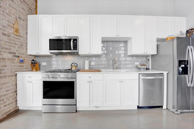 1801 S Michigan Ave Unit 701, Chicago, IL 60616 - kitchen featuring appliances with stainless steel finishes, brick wall, light countertops, and white cabinets