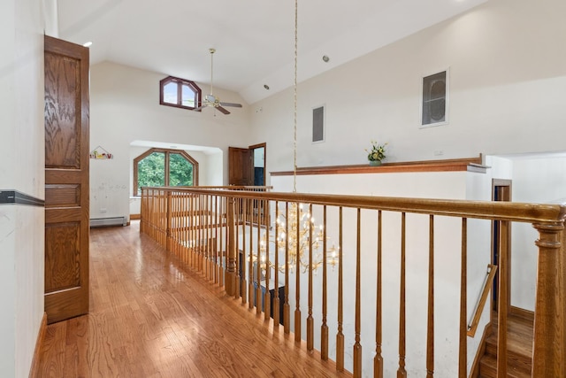 1313 Plum Tree Rd, Barrington Hills, IL 60010 - corridor with wood finished floors, baseboard heating, high vaulted ceiling, and an upstairs landing