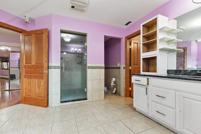 1313 Plum Tree Rd, Barrington Hills, IL 60010 - bathroom featuring tile walls, vanity, a shower stall, wainscoting, and tile patterned flooring