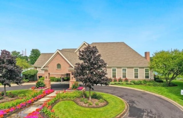 1811 Prairie Ridge Dr, Plainfield, IL 60586 - view of front of house featuring curved driveway and a chimney