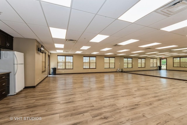 1811 Prairie Ridge Dr, Plainfield, IL 60586 - empty room with a paneled ceiling, plenty of natural light, and light wood-type flooring