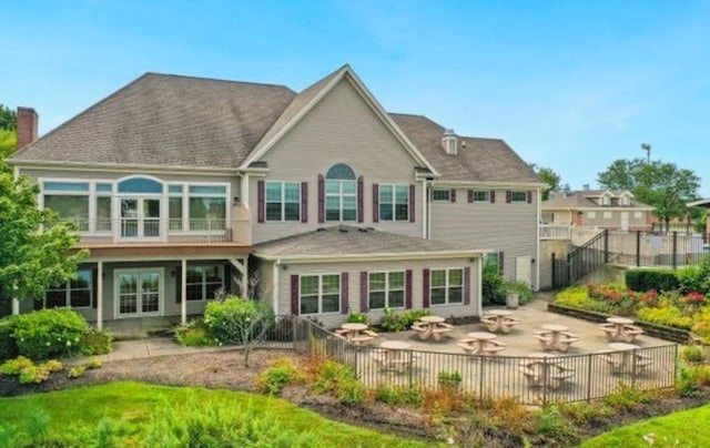 1811 Prairie Ridge Dr, Plainfield, IL 60586 - back of house with a patio area, a fenced backyard, and a chimney