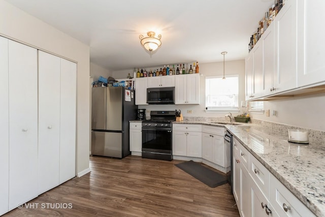 1811 Prairie Ridge Dr, Plainfield, IL 60586 - kitchen with black microwave, freestanding refrigerator, gas range oven, white cabinets, and dark wood finished floors