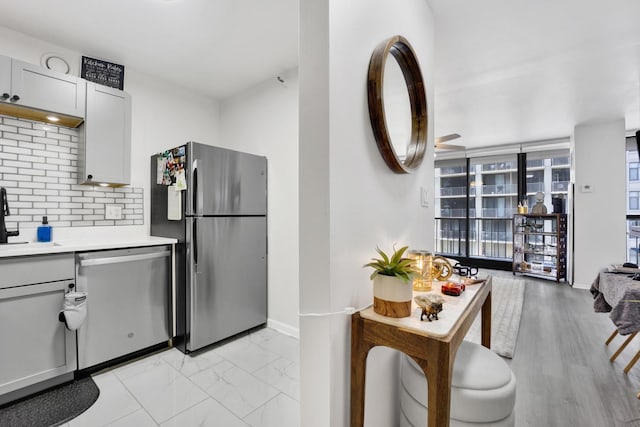 10 E Ontario St Unit 907, Chicago, IL 60611 - kitchen with appliances with stainless steel finishes, light countertops, decorative backsplash, gray cabinetry, and a ceiling fan