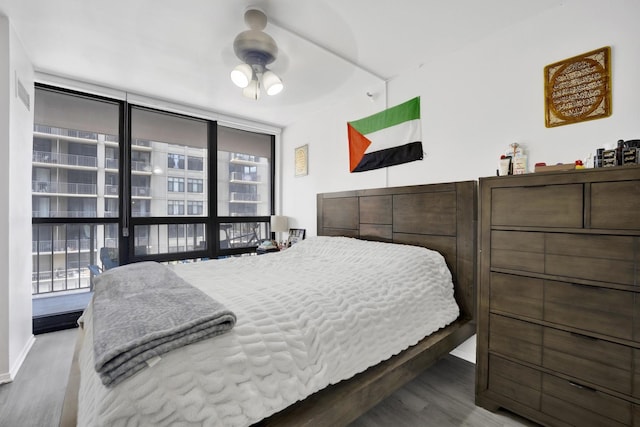 10 E Ontario St Unit 907, Chicago, IL 60611 - bedroom featuring wood finished floors and expansive windows