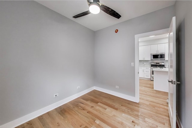 5735 S Fairfield Ave, Chicago, IL 60629 - spare room with a ceiling fan and light wood-style floors