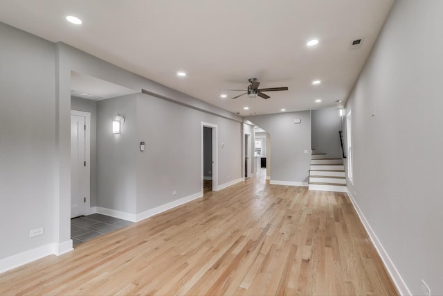 5735 S Fairfield Ave, Chicago, IL 60629 - unfurnished living room with ceiling fan, light wood finished floors, stairway, and recessed lighting