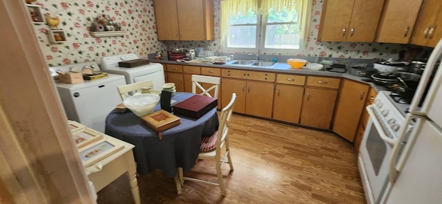 27375 W Nippersink Rd, Ingleside, IL 60041 - kitchen with separate washer and dryer, light wood finished floors, white gas stove, wallpapered walls, and brown cabinetry