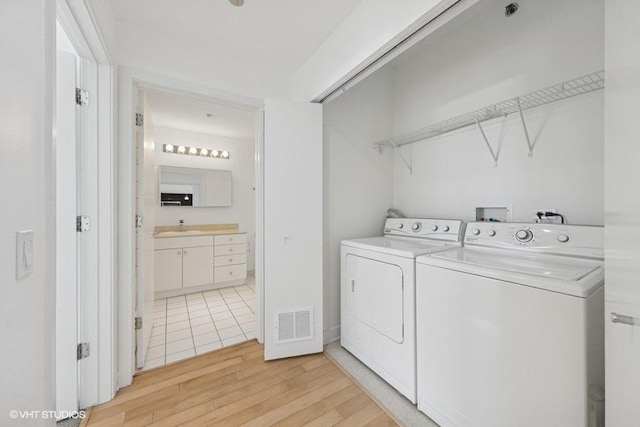 8 E Randolph St Unit 3007, Chicago, IL 60601 - washroom with washer and clothes dryer and light wood-style floors