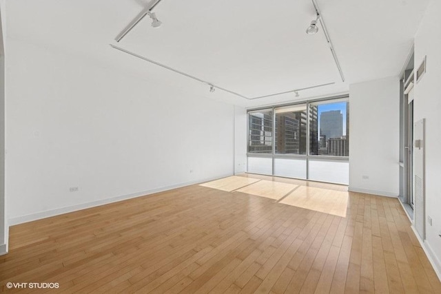 8 E Randolph St Unit 3007, Chicago, IL 60601 - spare room featuring rail lighting and light wood finished floors