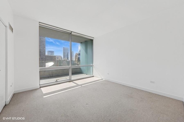 8 E Randolph St Unit 3007, Chicago, IL 60601 - carpeted empty room with expansive windows and a skyline view
