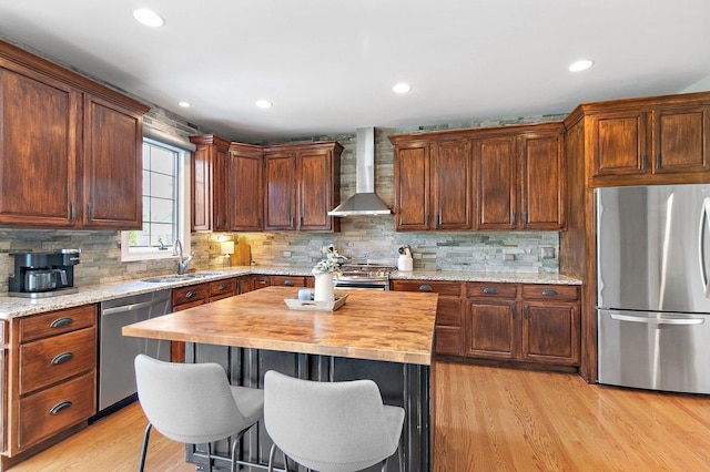29990 Fehmarn Way, Genoa, IL 60135 - kitchen with stainless steel appliances, wall chimney range hood, butcher block counters, light wood-style flooring, and tasteful backsplash