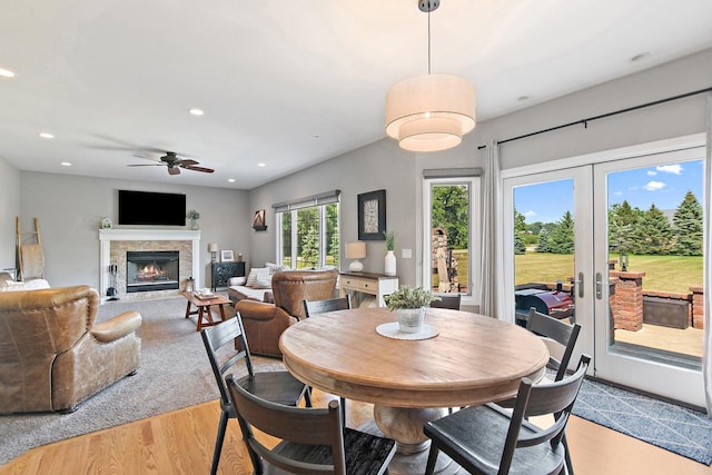 29990 Fehmarn Way, Genoa, IL 60135 - dining area with light wood-type flooring, french doors, recessed lighting, ceiling fan, and a glass covered fireplace