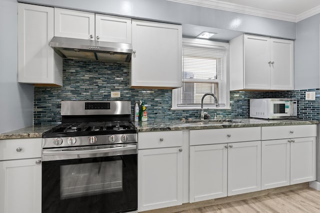 17317 Roy St, Lansing, IL 60438 - kitchen featuring stainless steel range with gas cooktop, exhaust hood, white microwave, white cabinets, and dark stone counters