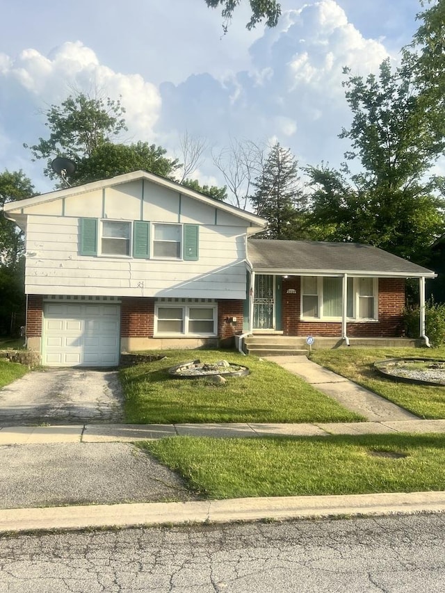 3325 Laurel Ln, Hazel Crest, IL 60429 - split level home featuring brick siding, an attached garage, a front lawn, and driveway