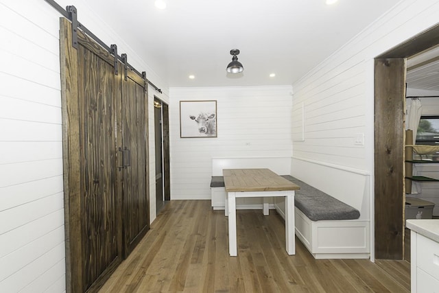 471 N W Ave, Elmhurst, IL 60126 - dining area featuring a barn door, wooden walls, wood finished floors, crown molding, and recessed lighting