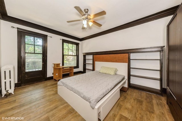 1455 E 56th St Unit 1E, Chicago, IL 60637 - bedroom with radiator heating unit, ornamental molding, wood finished floors, and ceiling fan