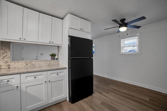 9444 Kelvin Ln Unit A-3211, Schiller Park, IL 60176 - kitchen with freestanding refrigerator, ceiling fan, dark wood-style flooring, a textured ceiling, and white cabinetry