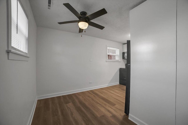 9444 Kelvin Ln Unit A-3211, Schiller Park, IL 60176 - spare room with a textured ceiling, dark wood finished floors, and a ceiling fan