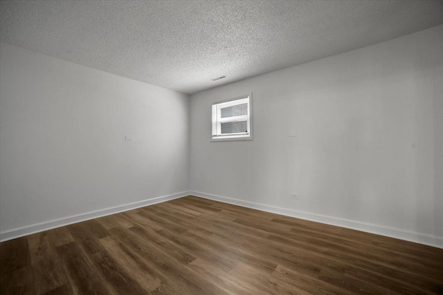 9444 Kelvin Ln Unit A-3211, Schiller Park, IL 60176 - unfurnished room featuring dark wood-type flooring and a textured ceiling