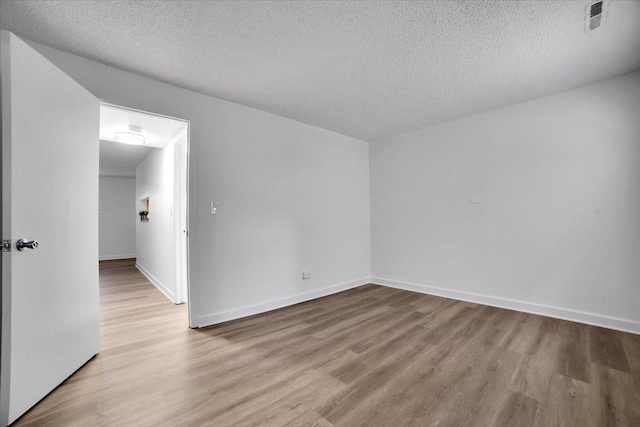 9444 Kelvin Ln Unit A-3211, Schiller Park, IL 60176 - spare room with wood finished floors and a textured ceiling