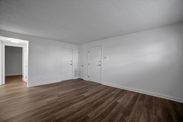 9444 Kelvin Ln Unit A-3211, Schiller Park, IL 60176 - spare room with dark wood-type flooring and a textured ceiling