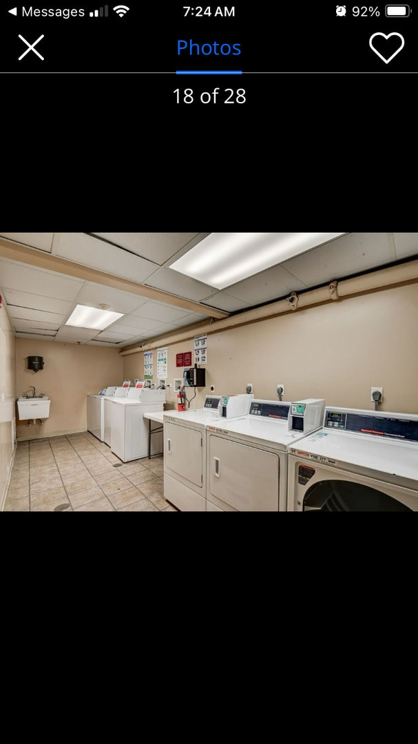 9444 Kelvin Ln Unit A-3211, Schiller Park, IL 60176 - shared laundry featuring washer and clothes dryer and light tile patterned floors